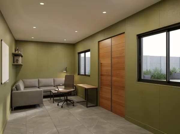 Design visualisation of a porta cabin interior with olive walls and recessed ceiling lights, a grey corner sofa, a small table, a desk with an office chair, wall shelves, a whiteboard, two windows and a tall wood-finish door