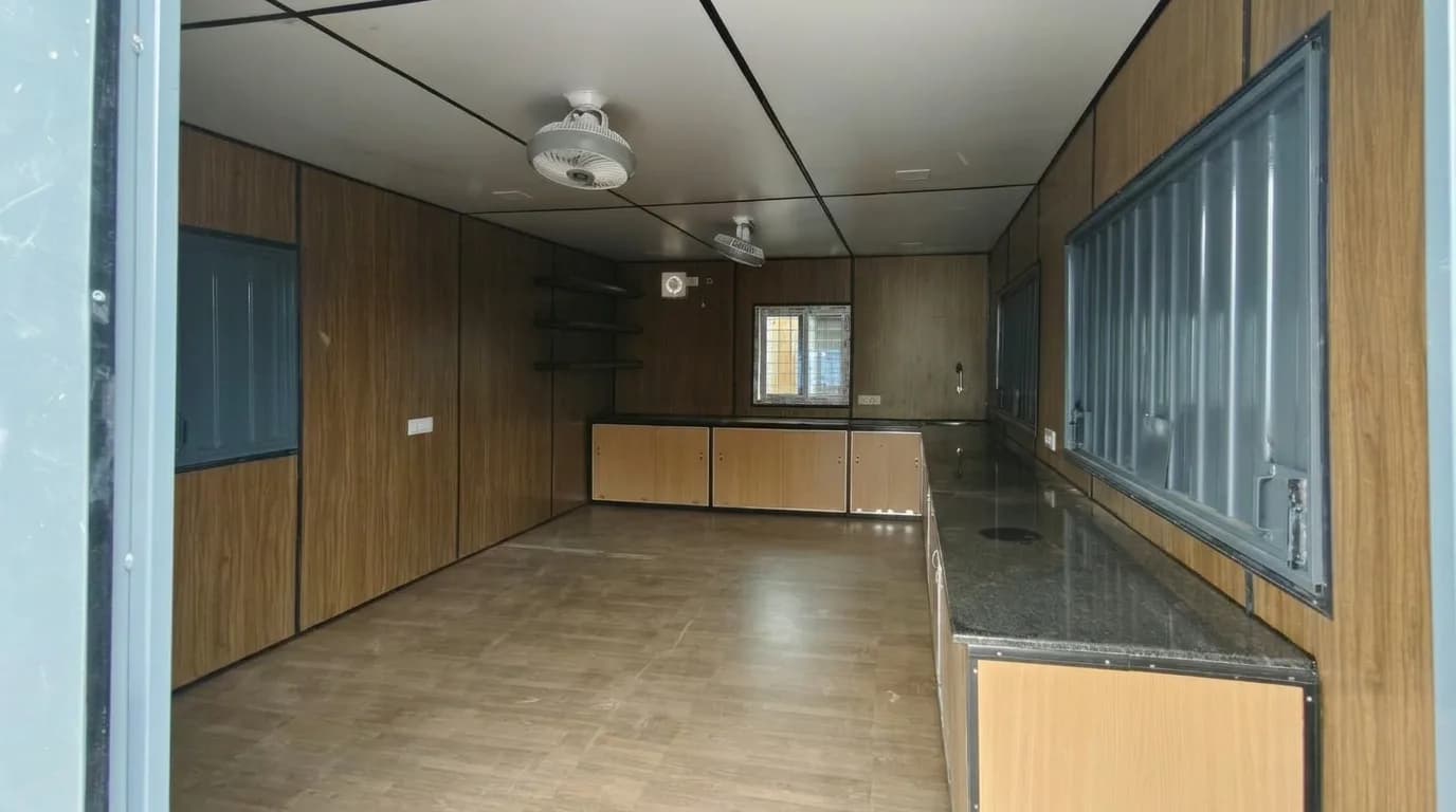 Portable Cafe Cabin interior with ceiling fans, LED lights and shelving