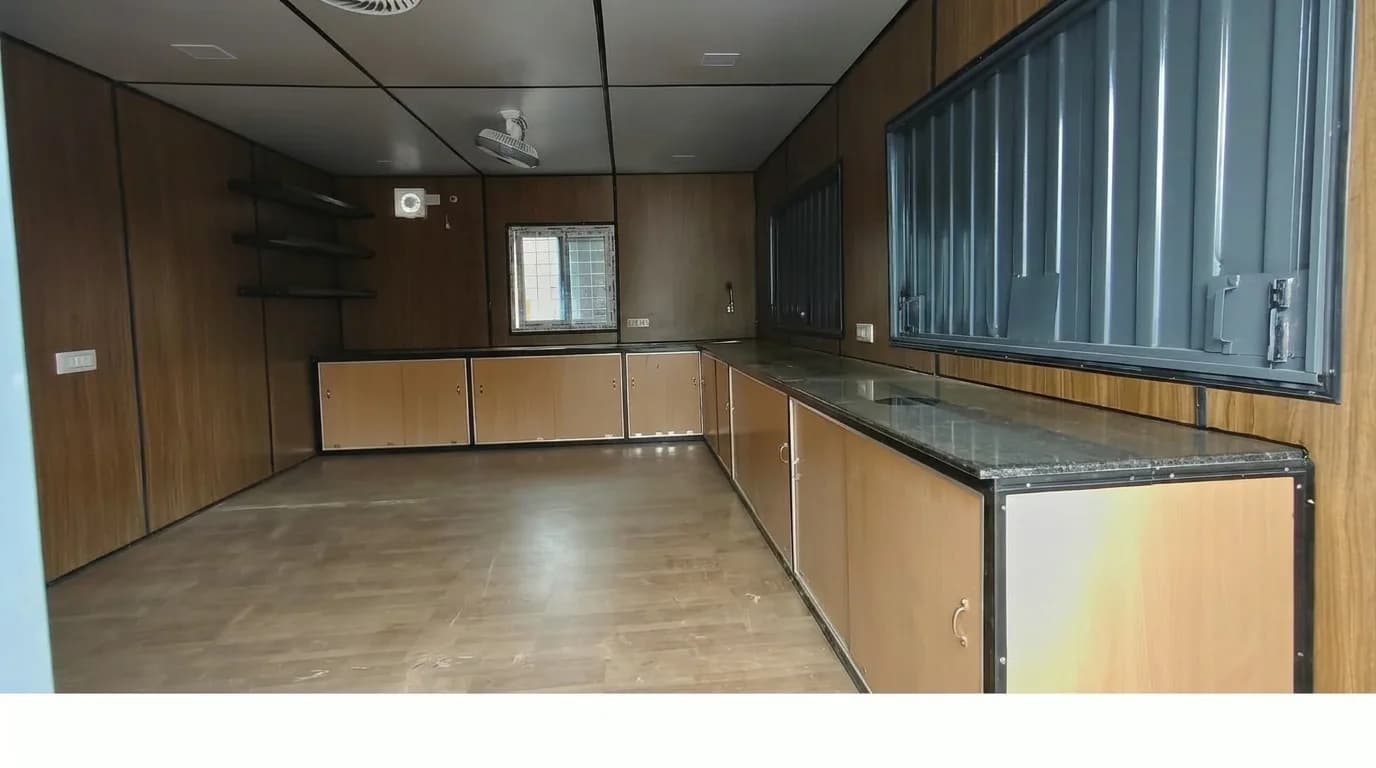 L-shaped kitchen counters with below-counter storage inside Portable Cafe Cabin