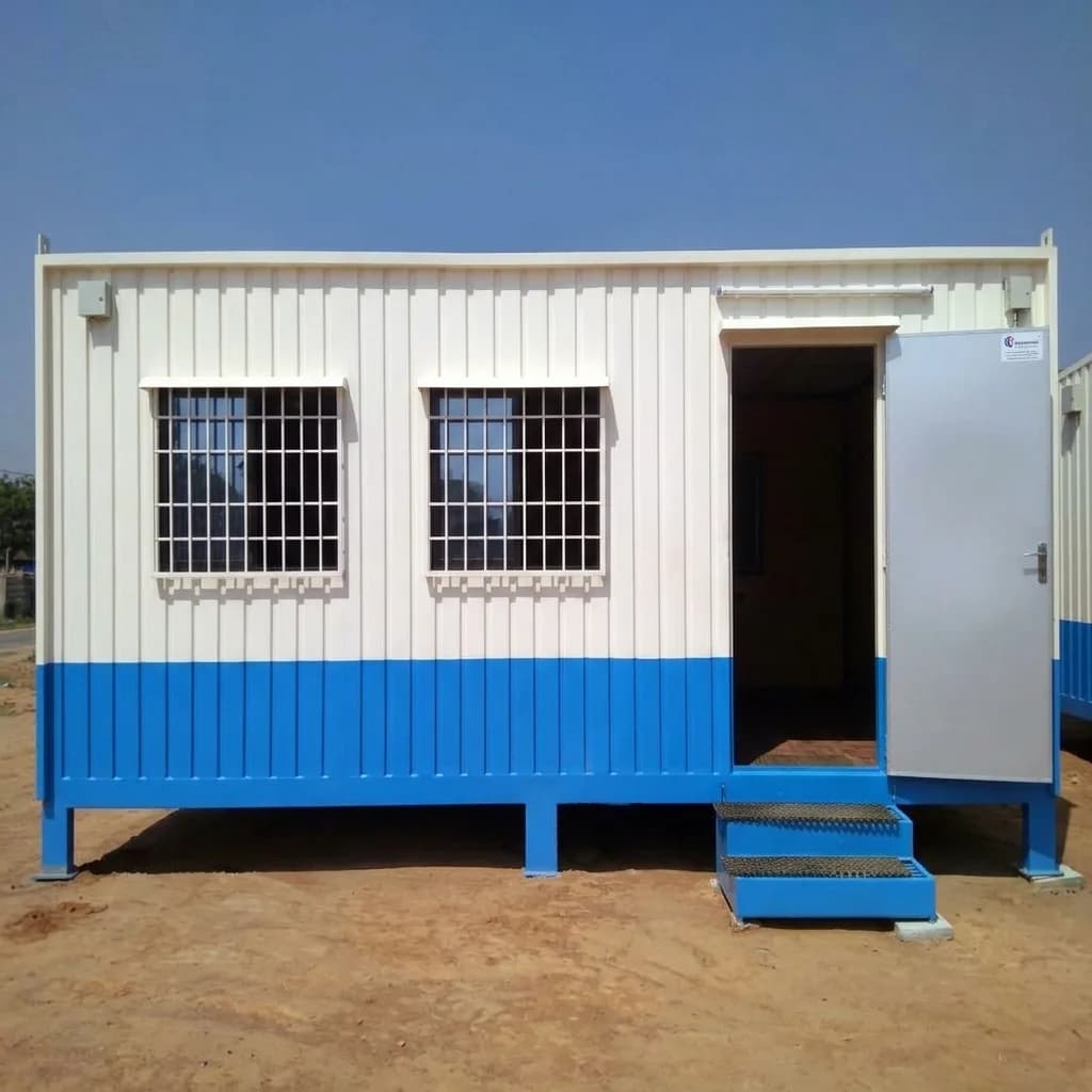 Front elevation of the rental container office cabin with two grilled windows and entrance steps