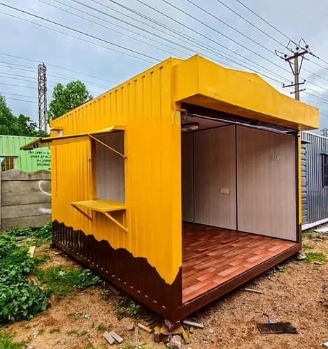 Portable shop cabin manufactured by Porta Cabin Systems with an open shopfront and side display counter.